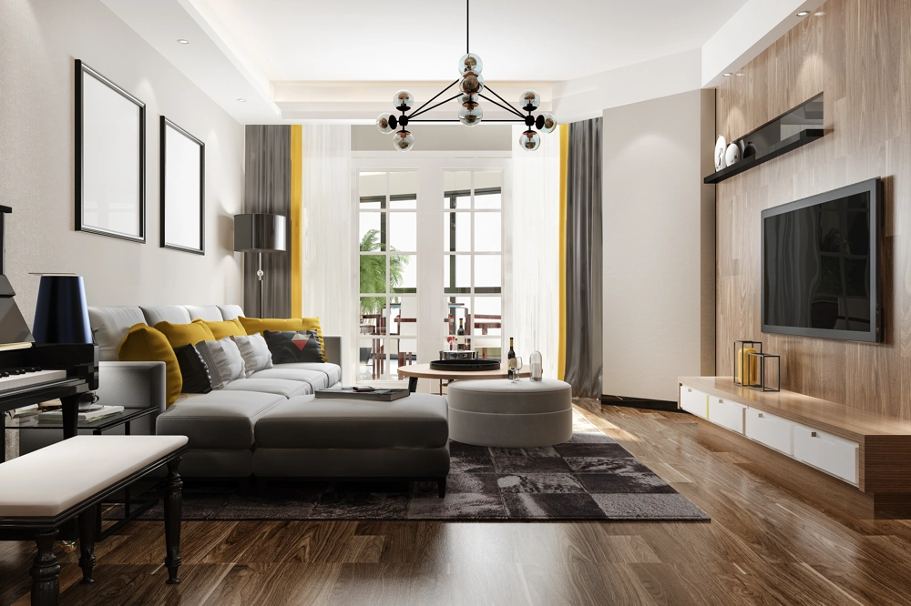 Moderne Wohnraumgestaltung mit grauem Ecksofa, gelben Kissen, runder Sitzinsel, TV-Wand und großem Fenster zur Terrasse