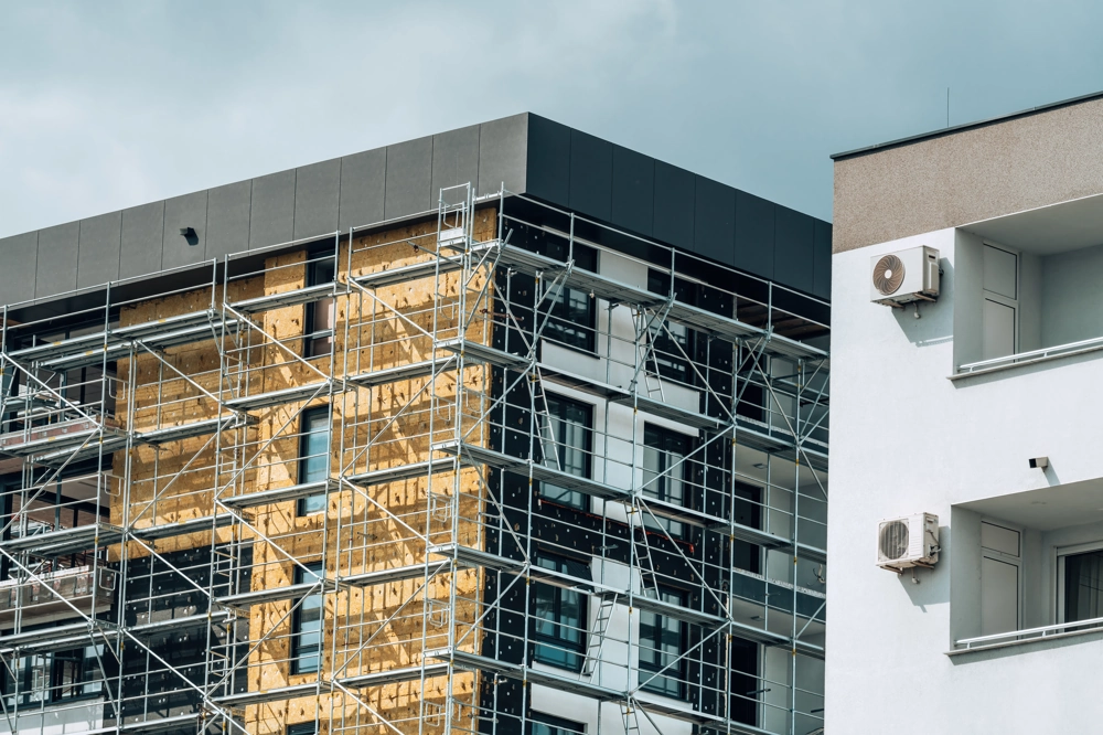 Gerüst vor moderner Wohnhausfassade mit aufgebrachten Dämmplatten für Fassadendämmung